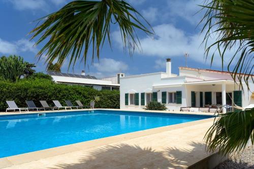 a villa with a swimming pool and a house at Villa Agua Turquesa in Punta Prima