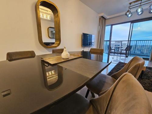 a dining room with a table and chairs and a mirror at Savyon View Royal Suites - Alefimmoed in Jerusalem