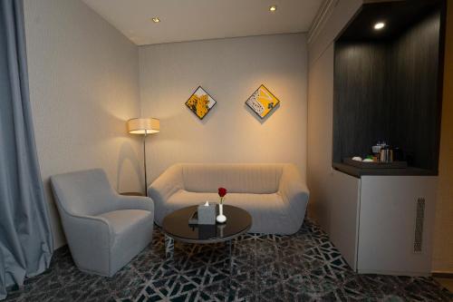 a living room with a couch and two chairs and a table at Executives Hotel - KAFD in Riyadh