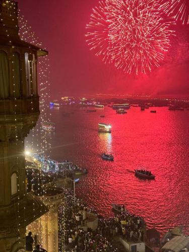 a firework display over a body of water with boats at Rana Mahal - a Boutique Place in Varanasi