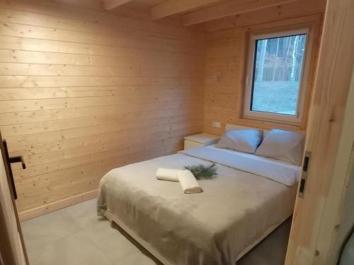 a bedroom with a bed in a wooden room at Gminny Ośrodek Sportów Wodnych w Białym Borze in Grudziądz
