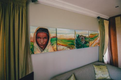 a painting of a woman on a wall at Castellon Boutique Hotel in Table View