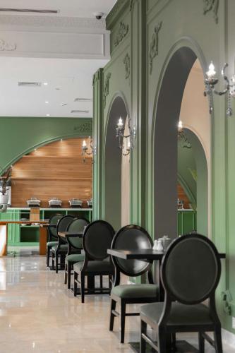 a row of tables and chairs in a restaurant at Levatio Suites Muscat, a member of Radisson Individuals in Muscat