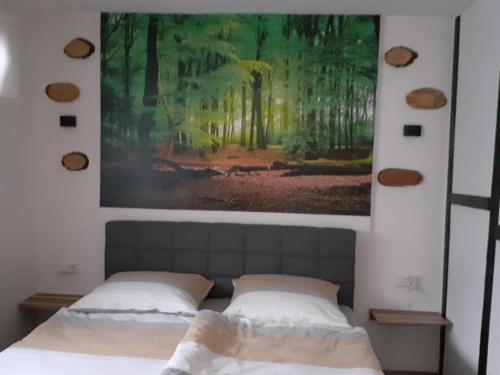 a bedroom with two beds and a painting on the wall at NEU! Ferienwohnung Rustica in Ellscheid