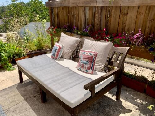 a bench with pillows sitting on a patio at Casa Amador in Alcácer do Sal