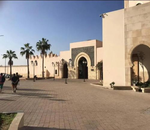 a person riding a bike in front of a building at Maison pres plus Grand Bazar d'Afrique Souk El Had in Agadir