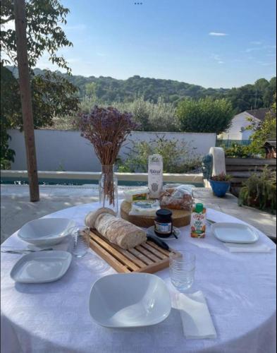 a table with white plates and bread on it at Casa Amador in Alcácer do Sal