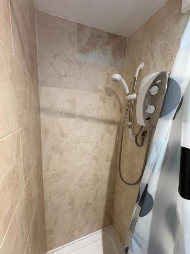 a bathroom with a shower with a toilet in it at The Peacock House 7 mins from Luton airport in Luton