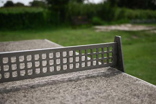 a metal bench sitting on top of a sidewalk at Tiny House Pioneer 4 - Green Tiny Spot Friesland in Schortens