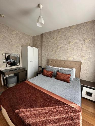 a bedroom with a large bed and a desk at SABİHA GOKCEN İSTANBUL HOUSES Airport in Istanbul