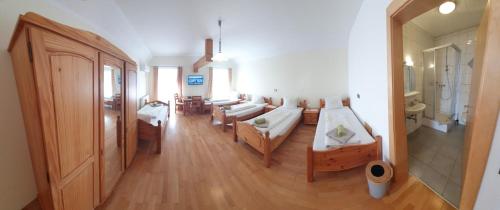 a room with a living room with a couch and a room with at Gasthof-Pension Ölberger in Wolfsberg