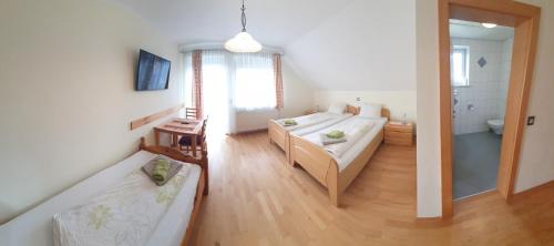 a room with a bed and a couch in it at Gasthof-Pension Ölberger in Wolfsberg