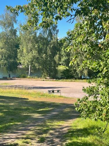 a park bench sitting in the middle of a field at Ådalsvägenhus in Fågelfors