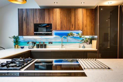 a kitchen with a sink and a stove at Lovely South Downs Town House in Upper Beeding