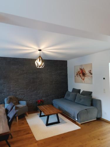 a living room with a couch and a table at Hanna's Traumwohnung in Kaltenleutgeben