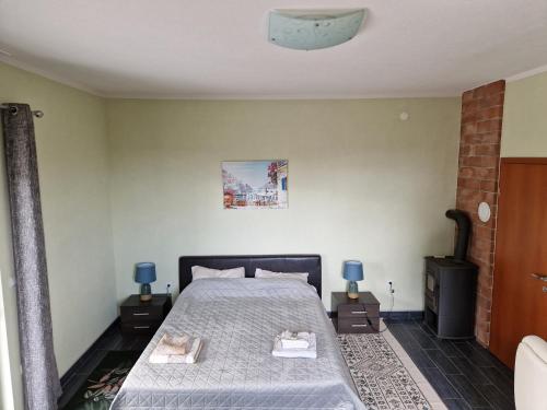 a bedroom with a bed and two night stands at Villa Aberdeen in Tivat