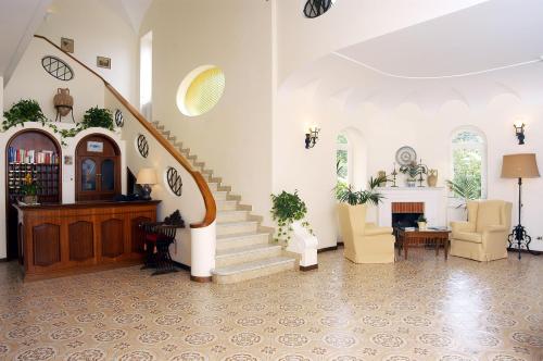 a living room filled with furniture and a stair case at Hotel Villa Sarah in Capri
