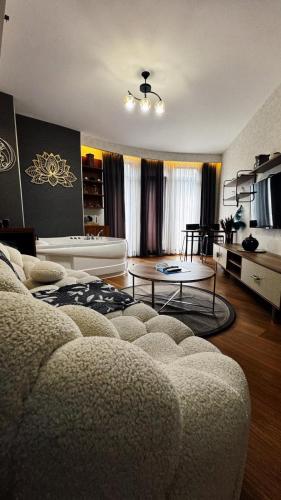 a living room with a couch and a table at SABİHA GOKCEN İSTANBUL HOUSES Airport in Istanbul