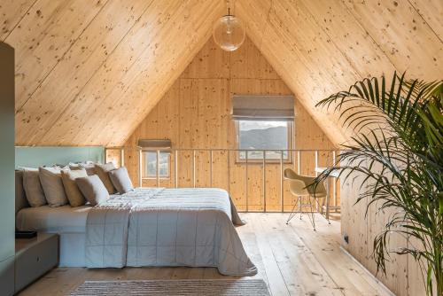 a bedroom with a bed in a wooden room at HONAY HOUSE with a stunning view of MOUNTAINS in Dursztyn