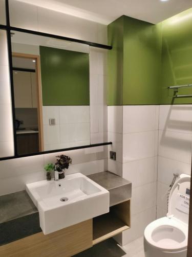 a bathroom with a white sink and a toilet at 3BR Davao Condo 7thfloor near Airport in Pagamikan
