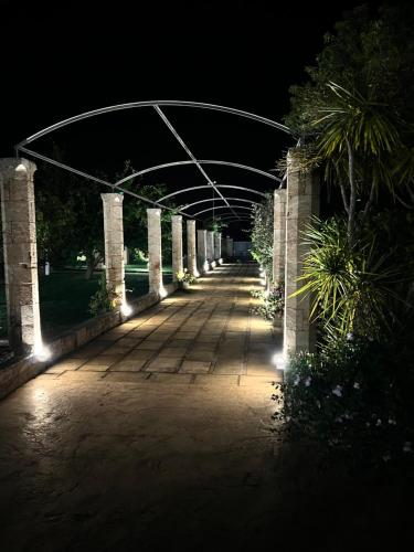 a walkway lit up at night with lights at Villa Anna - Suites & Events in Specchia