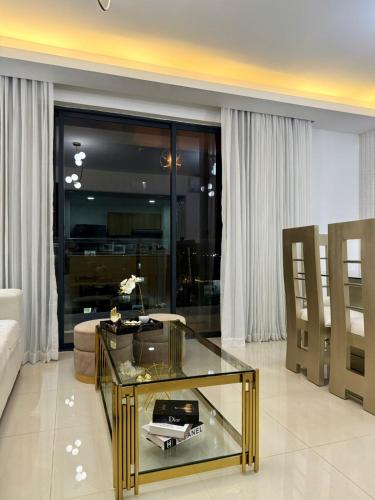 a living room with a glass table and a couch at Premium space in Santiago- 5 Min Away from airport in Santiago de los Caballeros