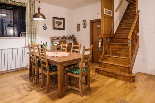a dining room with a wooden table and chairs at CASA NATURA - charming chalet with hot tub in Tuk Vojni