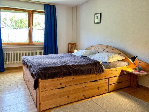 a bedroom with a large bed with a wooden dresser at Haus am Kreuzberg in Medebach