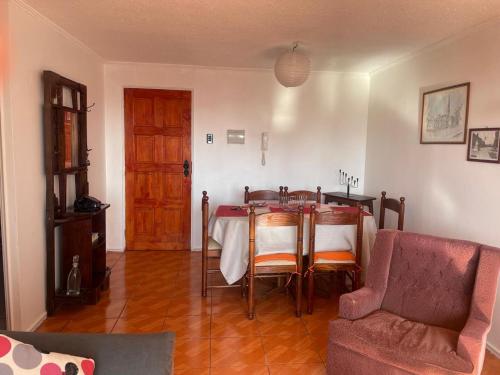 a living room with a table and a couch at DepartamentoSantaInes in Viña del Mar