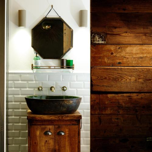 a bathroom with a bowl sink on a wooden vanity at The West Wing in Barnstaple