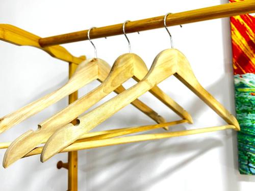 a group of wooden arrows hanging from a wooden pole at Tirana Square Hotel in Tirana