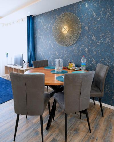a dining room with a wooden table and chairs at La Bonbonnière by Leslodgespa in Hésingue