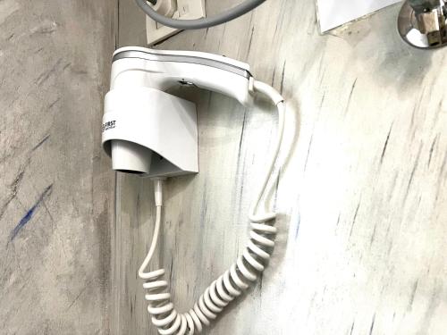a white phone hanging on a wall at Tirana Square Hotel in Tirana