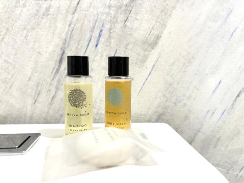 two bottles of essential oils sitting on a table at Tirana Square Hotel in Tirana