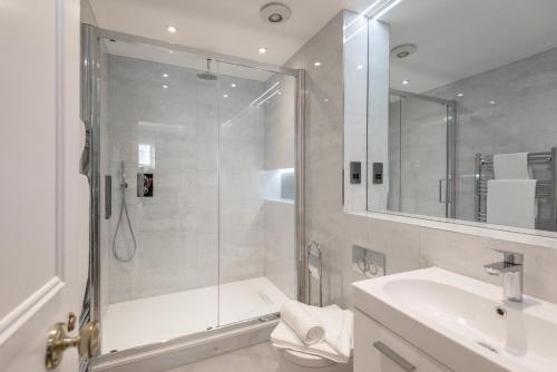 a bathroom with a shower and a toilet and a sink at Mayfair private Apartments in London