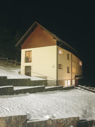 a building in the snow at night at Karmelitański Dom Gościnny in Zawoja