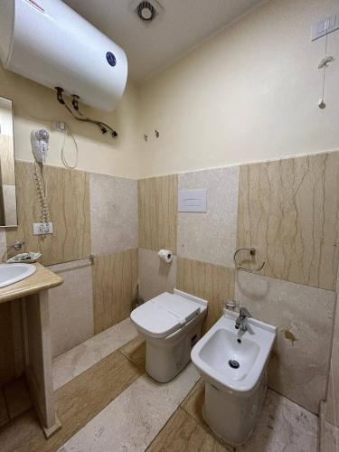 a bathroom with a toilet and a sink at 55 Aira Hotel in Palermo