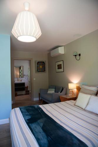 a bedroom with a bed and a living room at la villa miel in Opio
