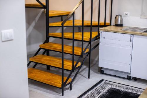 a staircase with yellow steps in a room with a kitchen at EKA Luxury Seaview Apartments in Vlorë