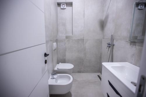 a bathroom with a toilet and a sink and a shower at EKA Luxury Seaview Apartments in Vlorë