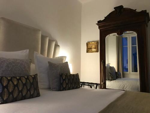 a bedroom with a bed and a large mirror at Luxurious Townhouse 10 mins walk to Epernay centre in Épernay