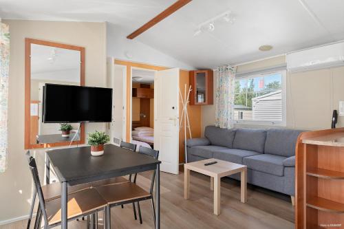 a living room with a couch and a table at First Camp Lilleby in Torslanda