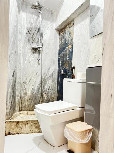 a bathroom with a toilet and a shower at Tirana Square Hotel in Tirana