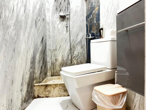 a bathroom with a white toilet and a shower at Tirana Square Hotel in Tirana