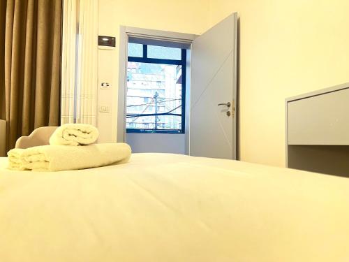 a bedroom with a bed with towels on it at Tirana Square Hotel in Tirana