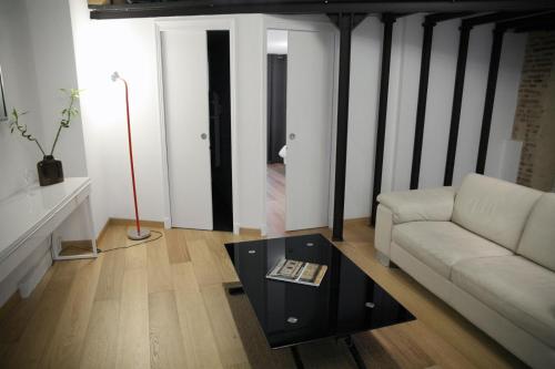 a living room with a couch and a coffee table at Atout Carmes in Toulouse