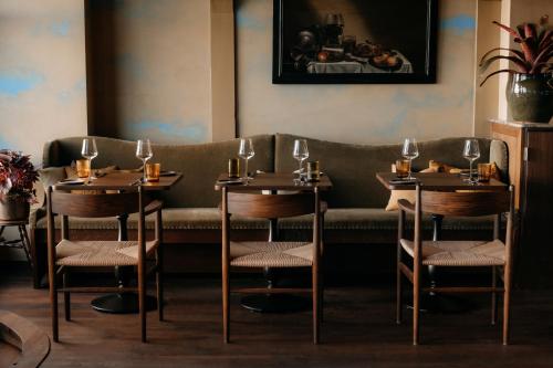 a restaurant with two tables and chairs and a couch at De Durgerdam, Amsterdam in Amsterdam