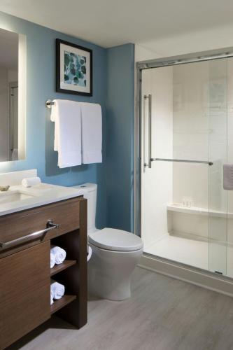 a bathroom with a toilet and a shower at Residence Inn by Marriott Miami Beach South Beach in Miami Beach