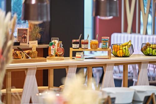 a table with different types of food on it at Novotel Rouen Centre Cathédrale in Rouen