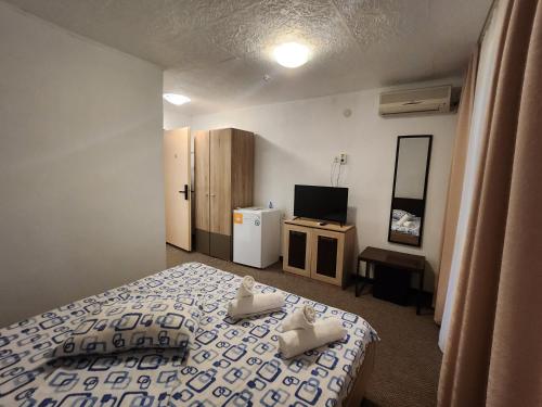 a bedroom with a bed and a tv in it at Casa Daria in Costinesti